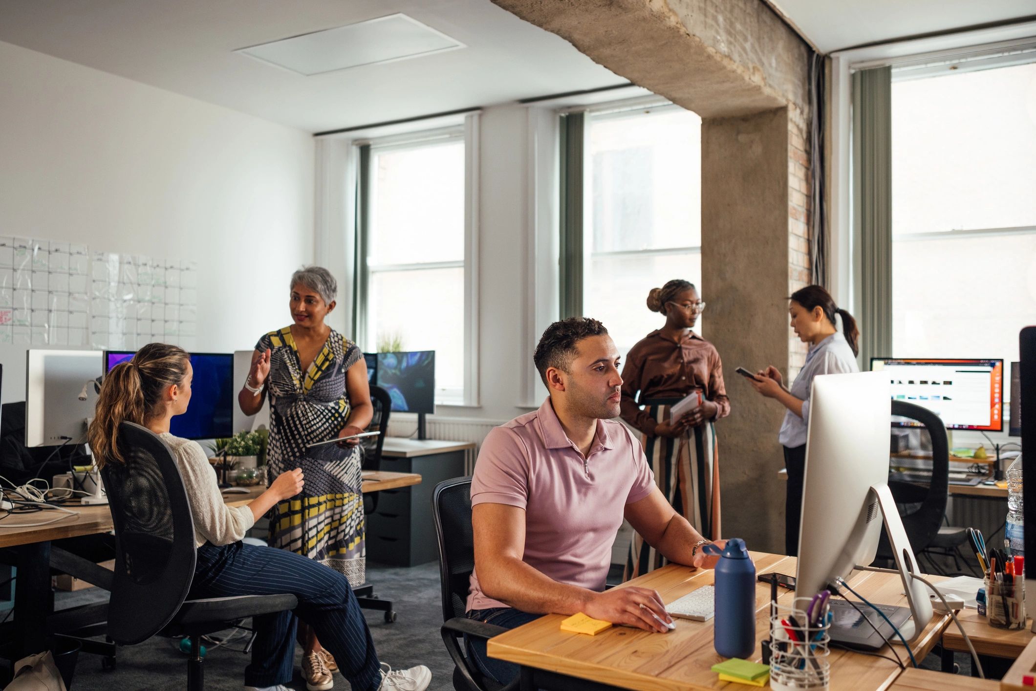 Professional tech team working together in a modern office